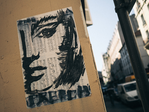 Sketch of woman on newsprint with words FRENCH below her face - Paris Street Art 2017 - Artist Unknown