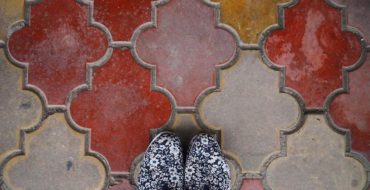 the truth about traveling solo - shoes on colorful tiles in Romania