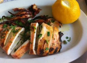 Photo showing grilled calamari with parsley and lemon at Parodosiako Tavern in Athens Greece