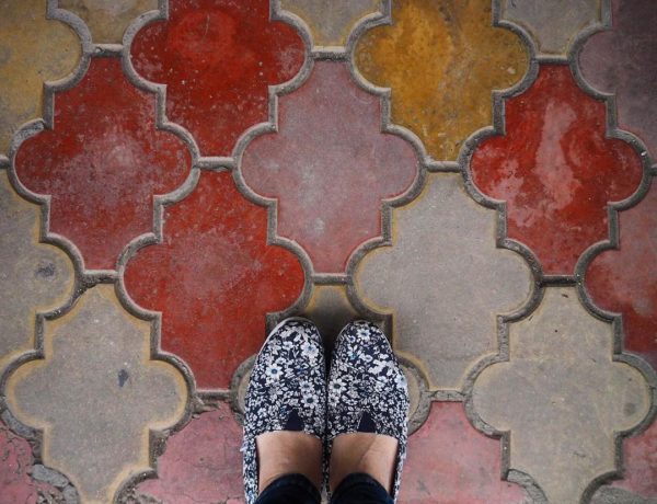 the truth about traveling solo - shoes on colorful tiles in Romania